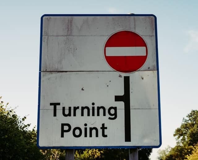 A UK road sign displaying no entry and a turning point.